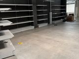 many empty shelves in the middle of a large room