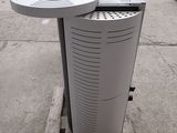 two air conditioners sitting on a pallet in a parking lot