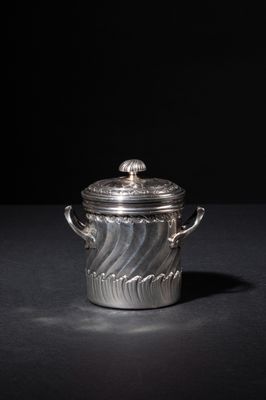 an old silver pot with a lid on a black surface