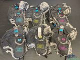 six pairs of winter mitts are lined up on a table