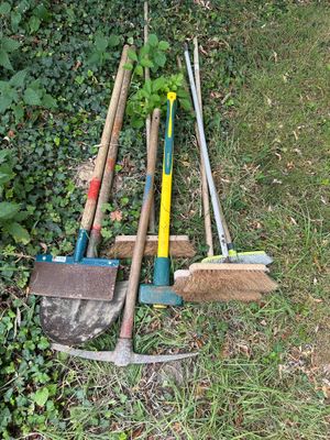 a lot of tools that are laying out in the grass