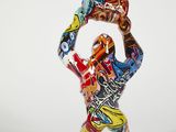 a sculpture of a man holding a skateboard in his hands
