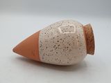 a small cone shaped object on a white surface