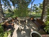 many benches and tables in the shade of the trees