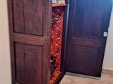 a tall wooden cabinet in the corner of a room