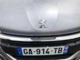 the front of a silver car with a number plate on it