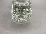 a glass vase with water inside of it on a table