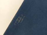 a close up of a blue shirt with a small hole in it
