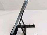 a cell phone that is on a stand on a table