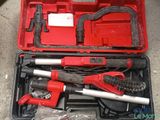 a red tool case with tools in it on the floor