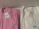 two shirts are sitting on a shelf next to each other