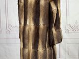 an image of a fur coat on a mannequin stand in a room