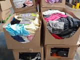 several boxes of clothing are stacked on top of each other in a warehouse