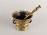 an antique brass mortar with a pestula in it on a white surface