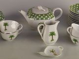 a lot of cups and saucers sitting on a table