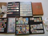 a lot of stamps and stamps in a folder on the table
