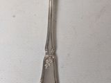 a silver spoon with a fork on it on a table