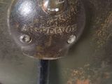 a close up of a metal object on a white surface