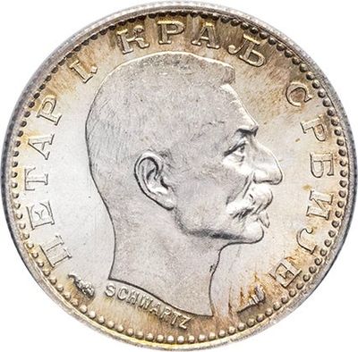 a close up of a coin with a man ' s face on it