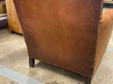 an image of a brown leather chair sitting in a room