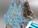 a blue object with a rock on top of it