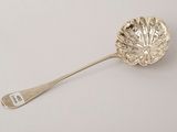 an antique silver spoon with a leaf design on it and a spoon with a spoon handle