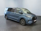 the blue van is parked in a large room with a black floor