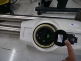 a person pressing a button on a machine in a factory