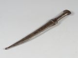 a small metal object on a white surface