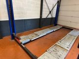 a couple of metal bars sitting on top of a wooden floor