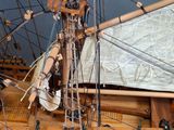 a wooden model of a boat on display in a museum