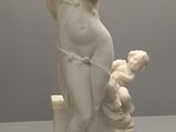 statue d'une femme tenant un bébé et un ours en peluche