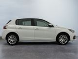 the white car is parked on the concrete floor in the room