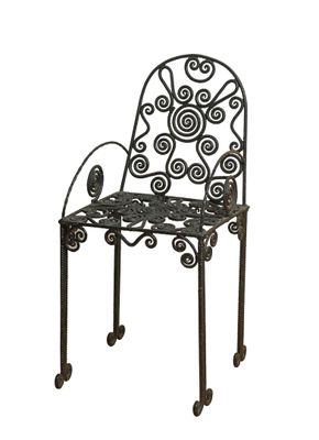 an image of a metal chair with a bird on it