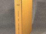 a yellow book box with the cover open on a grey background