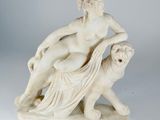 marble statue of a woman and a dog on a white surface