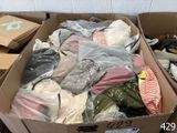 a cardboard box filled with clothes and other items