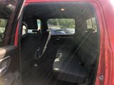 a red truck with a black seat in the back of it
