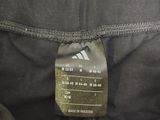 a close up of a black pants with a label on it