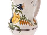a white vase with a floral design on it