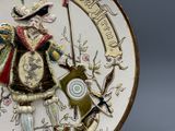 a decorative plate with a picture of a man holding a bow and arrow