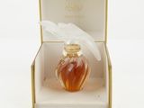 an image of a bottle of perfume in a box on a white surface