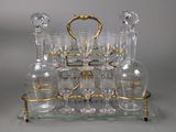 a glass tray with a lot of wine glasses on it