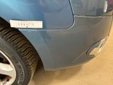 a close up of a blue car with a sticker on it