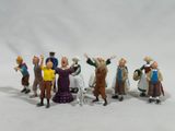 toy figurines of a group of people standing in front of a white background
