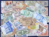a lot of different foreign currency on the table