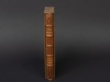 a brown book sitting on top of a black surface