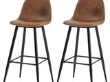 une paire de tabourets de bar en cuir marron avec des pieds noirs