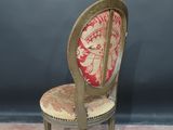 an old chair with a red and gold upholstered seat