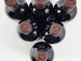 several bottles of wine are arranged in a circle on a white surface